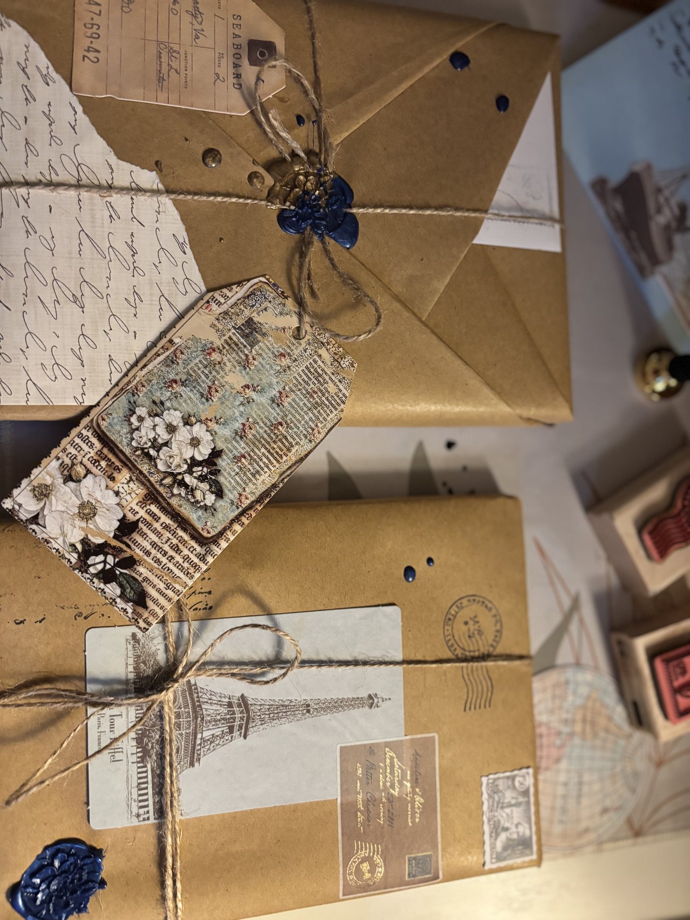 Kraft-wrapped correspondence parcels with wax seals, vintage tags, and twine