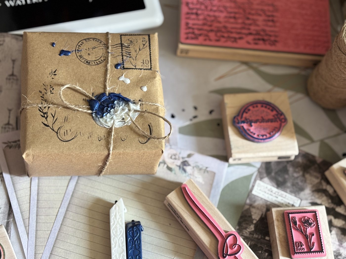 Stamps, wax sticks, and a sealed parcel among the tools of slow correspondence